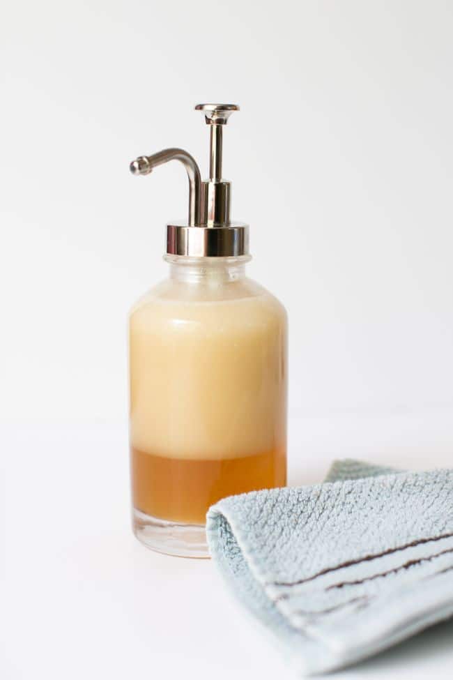 Coconut Oil Skincare Recipes: DIY Body Wash in glass pump bottle with blue towel