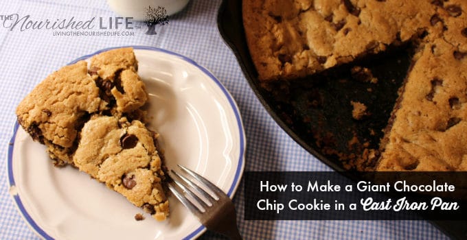 A yummy chocolate chip cookie slice from a giant cookie in a cast iron pan