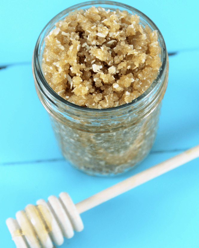 oatmeal honey sugar scrub in a mason jar on a bright blue table