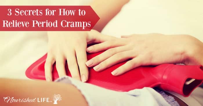 3 Secrets for How to Relieve Period Cramps: red hot water bottle on woman's lower stomach