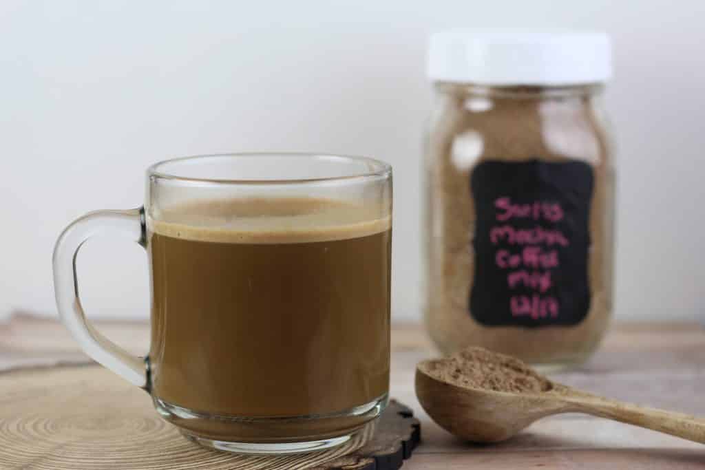 Swiss Mocha Coffee Mix Recipe in a glass cup with scoop of the powder next to it