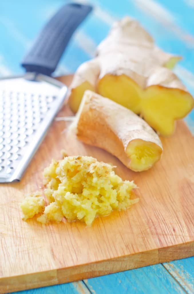 fresh grated ginger on a wooden cutting board